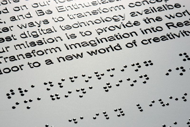 Embossed text above Braille